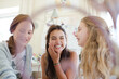 © KOTO - Three teenage girls playing on bed in bedroom