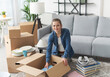 © StockPhotoPro - Happy woman moving in her new home