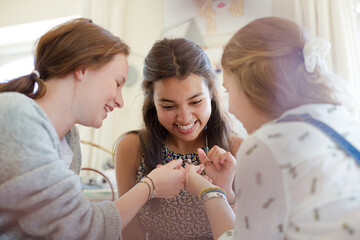 Wall Mural - Three teenage girls relaxing in bedroom