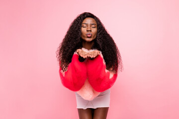 Poster - Portrait of adorable dark skin person closed eyes hands palms send air kiss camera you isolated on pink color background