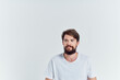 © SHOTPRIME STUDIO - bearded man in white t-shirt sits on a chair light background