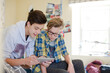 © KOTO - Two teenage boys having fun while using digital tablet