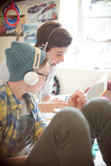 Canvas Print - Two teenage boys using electronic devices in room