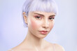 © deniskomarov - Cool young blond girl with healthy ideal glowing skin,  lavender hair and modern gentle make up, naked shoulders isolated on studio background. Advertising for skincare cosmetics