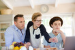 © KOTO - Teenage boys with father using laptop in dining room