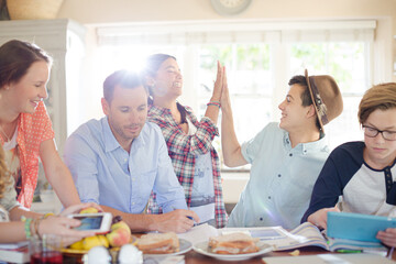 Wall Mural - Group of teenagers doing high five in living room