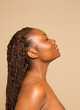 © Phiwo Ndlovu/Cultura Creative - Profile of shirtless woman with braided hair