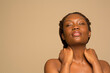 © Phiwo Ndlovu/Cultura Creative - Portrait of shirtless woman touching neck