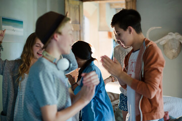 Wall Mural - Group of teenagers dancing in living room