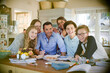 © KOTO - Group of teenagers with mid adult man sitting at table in dining room