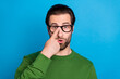 © deagreez - Photo of young shocked amazed businessman in spectacles hear unbelievable news isolated on blue color background