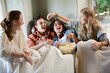© KOTO - Group of teenagers throwing popcorn on themselves on sofa