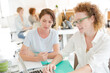 © KOTO - Portrait of women smiling in office with laptop on desk