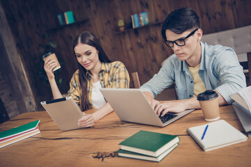 Poster - Portrait of two attractive creative friends friendship doing task researching data information at library loft industrial interior indoors