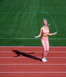 energetic woman athlete jumping on skipping rope warm up do sport workout, physical training.