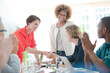 © KOTO - Office workers shaking hands at desk