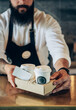 © Tijana - An Anonymous Barista Serving Two Take Away Paper Cup of a Coffee in a Cafe.Close up photo of a waiter hands giving disposable tray with two cups of take out coffee with loyalty card in a coffee shop.