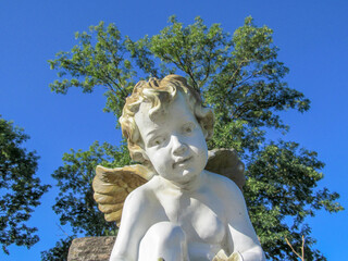 Wall Mural - The sculpture of an angel boy is made of stone