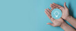 © LAONG - Idea innovation and inspiration concept, Woman hand holding light bulb icon on blue paper cut, concept creativity with bulbs that shine glitter, Inspiration ideas for sustainable business development