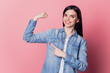 © Tetiana - Close-up portrait of pretty cute cheerful girl point finger strong arm muscle isolated on pink pastel color background