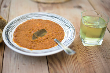 Wall Mural - Lentil soup , on a wooden table, traditional Greek food