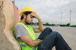 © anut21ng Stock - Asian man construction worker feeling stress and depressed about his job