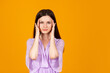 © Lustre Art Group  - Portrait of young stressed caucasian girl isolated on orange background