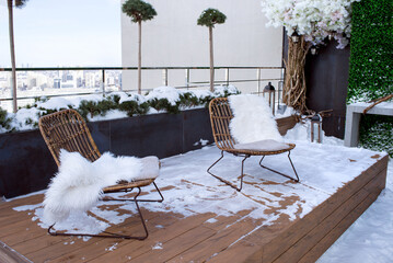 Wall Mural - Winter in the city. A cozy place to relax and party. View of the city from the attic of the house. Attic in the snow.