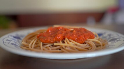 Wall Mural - Crop cook adding marinara sauce on spaghetti