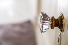 An Antique Vintage Glass Doorknob To A Narrow Bathroom In A Small Cottage House