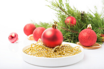 Wall Mural - Christmas tree toys on a Christmas tree branch isolated on a white background, selective focus