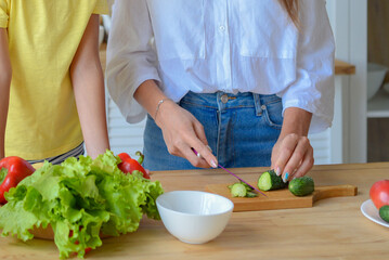 beautiful young woman housewife prepares food in the kitchen. healthy eating concept