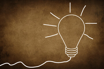 Wall Mural - A white bulb on a dark brown textured background, symbol for idea, creativity, business, planing