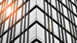 © Grand Warszawski - Modern architectural details. Modern glass facade with a geometric pattern. Contemporary corporate business architecture. Red sun on horizon. Black and white toned image.