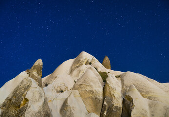 Canvas Print - Rocks and the sky with stars. View of the rocks at night. Landscape in the summertime. Natural background. Vacation and tourism.