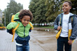 © Girts - Little boys with back packs. Two African American boys next to the school. Back to the school concept. Kids standing outside and happy to meet each others. Happy black children. First day of school