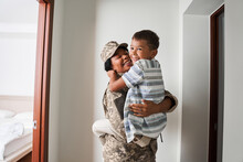 Black Female Soldier Holds Son On Arms After Army