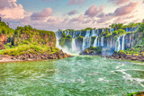 Shot of Iguazu Falls between Argentina and Brazil in the background of the cloudy sky.