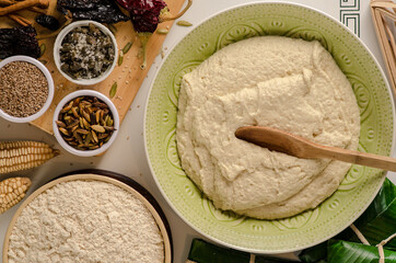 Dough for tamales and some ingredients.