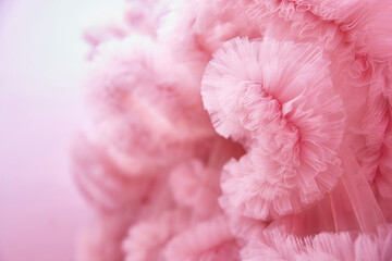 Texture Pink background from the airy fabric of the dress. Copy space for text about design and fashion