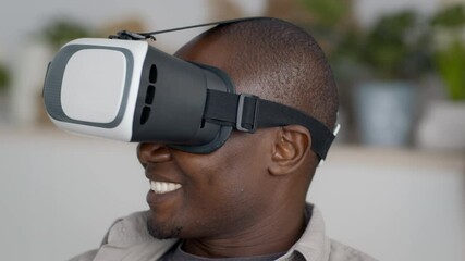 Wall Mural - Excited Black Man Wearing VR Glasses Experiencing Virtual Reality Indoors