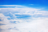 Fototapeta Londyn - White clouds on blue sky background view from above, airplane flight landscape, beautiful aerial cloudscape, skies backdrop, fluffy cloud texture, sunny heaven, cloudy weather, cloudiness, copy space