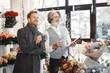 © prostooleh - Senior man florist helping male client to choose bouquet in flower shop