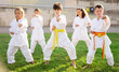 © JackF - Barefoot kids doing kata during outdoor karate training.