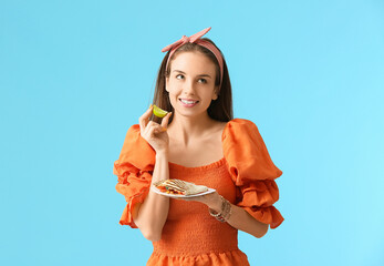 Sticker - Beautiful young woman with tasty quesadilla on color background