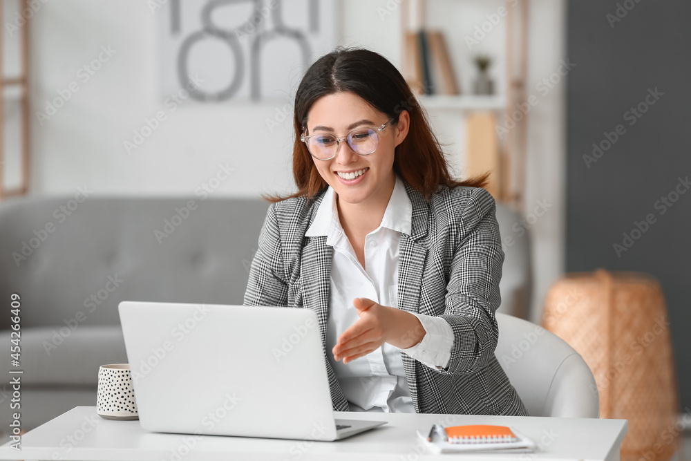 Young woman having interview online at home