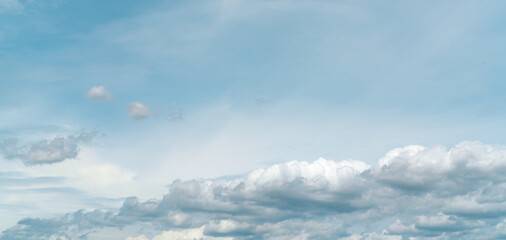 Wall Mural - panorama view of white fluffy clouds on blue sky. close-up white cumulus clouds texture background. 