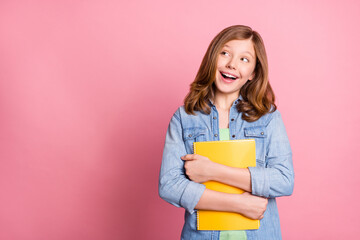 Poster - Photo portrait girl smiling keeping copybook looking copyspace isolated pastel pink color background