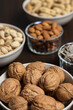© l_martinez - Assortment of nuts in different bowls: almond, walnut, peanut, pistachio and sunflower seed