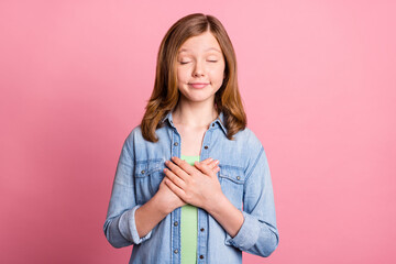 Sticker - Photo portrait girl smiling keeping hands on heart thankful isolated pastel pink color background